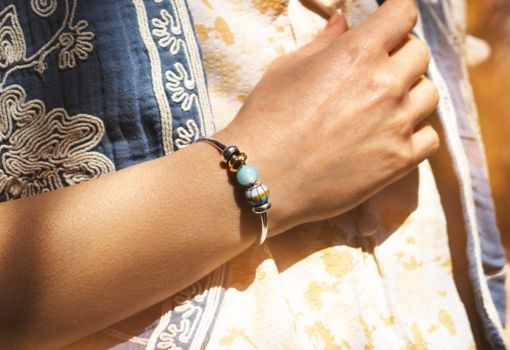 Woman wearing a silver plated bangle with beads