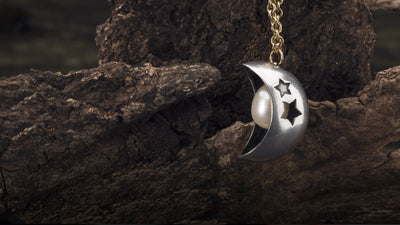 Moon and star bead on a gold fantasy necklace with a white pearl