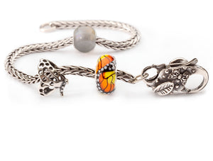 Sterling silver Trollbeads foxtail bracelet with the round labradorite bead, a silver butterfly bead, the orange and yellow monach butterfly bead in glass and a butterfly clasp