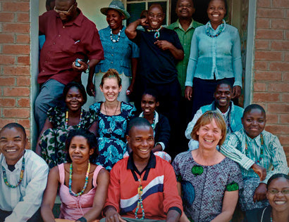 Lise Aagaard next to a group of people that were a part of Uniques project