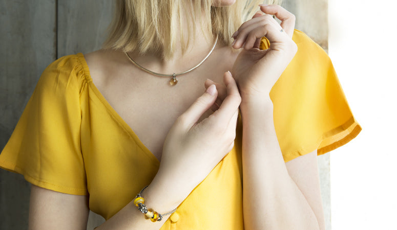 Model wearing Neck Bangle and trollbeads bracelet with beads