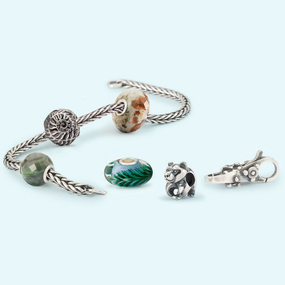 Foxtail bracelet chain with a garnet feldspar bead, Round Green Calcite Facet Bead, fern glass bead, fern selver bead , my sweet bear silver bead, and a wisdom clasp