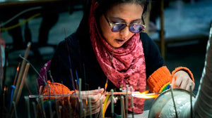 Woman making unique beads